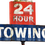Towing,Sign,At,A,Repair,Shop,Along,Interstate,5,In