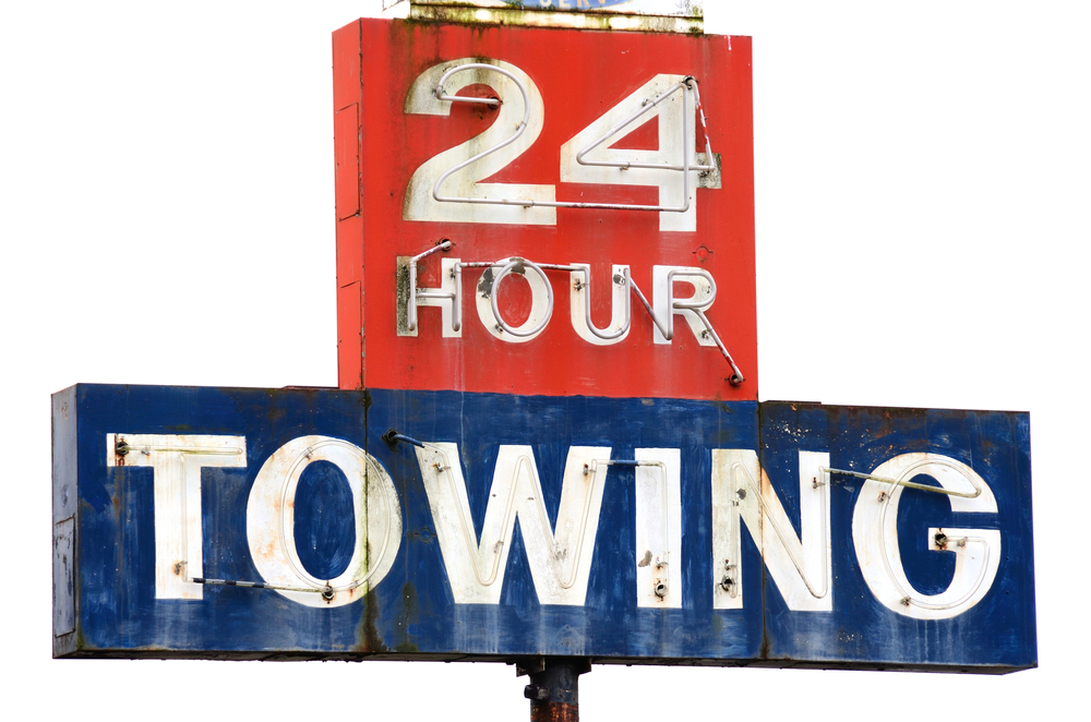Towing,Sign,At,A,Repair,Shop,Along,Interstate,5,In