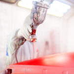 Close-up,Of,Spray,Gun,And,Worker,Painting,A,Car