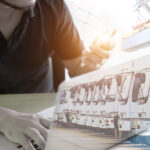 Logistic,Concept,,Manager,Working,With,Laptop,And,Smartphone,For,Import