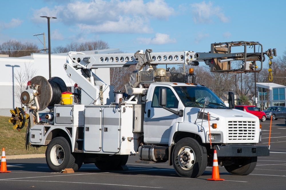 Front,And,Side,View,Of,Parked,Communication,Utility,Trucks,In